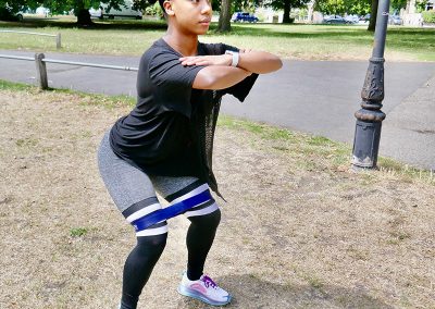 Grace activating her Glutes with a knee banded squat