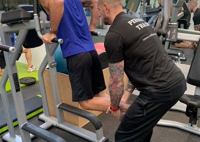 Gustavo executing tricep dips with the assistance of Steve