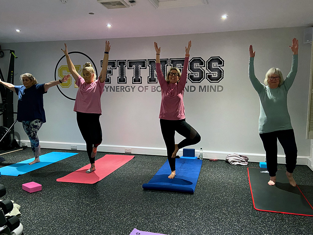 Vinyasa flow style yoga class with participants at the SW Fitness studio in Tarporley, Cheshire.